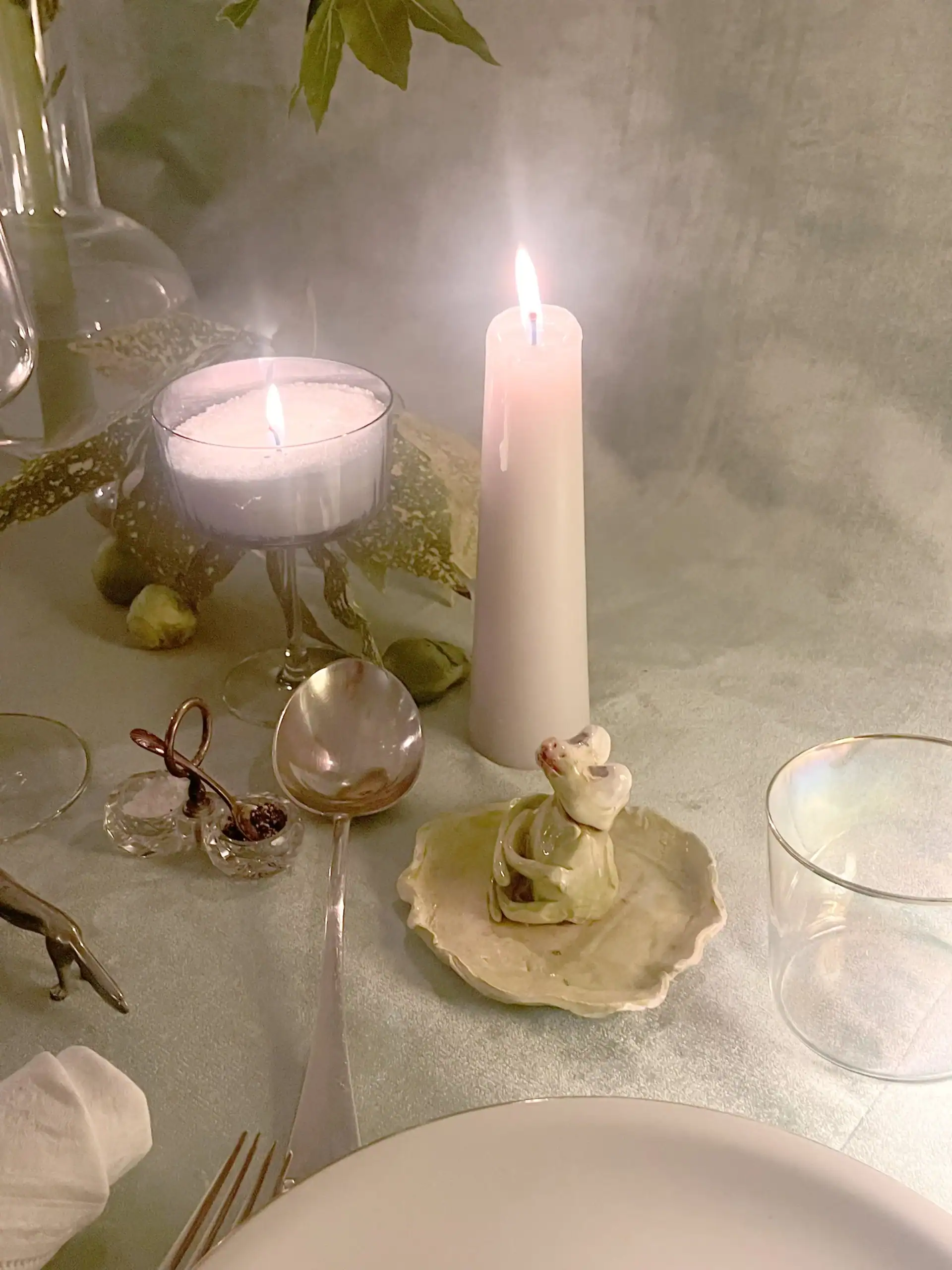 My daughter’s ceramic creation next to my grandmother's porcelain and silver cutlery